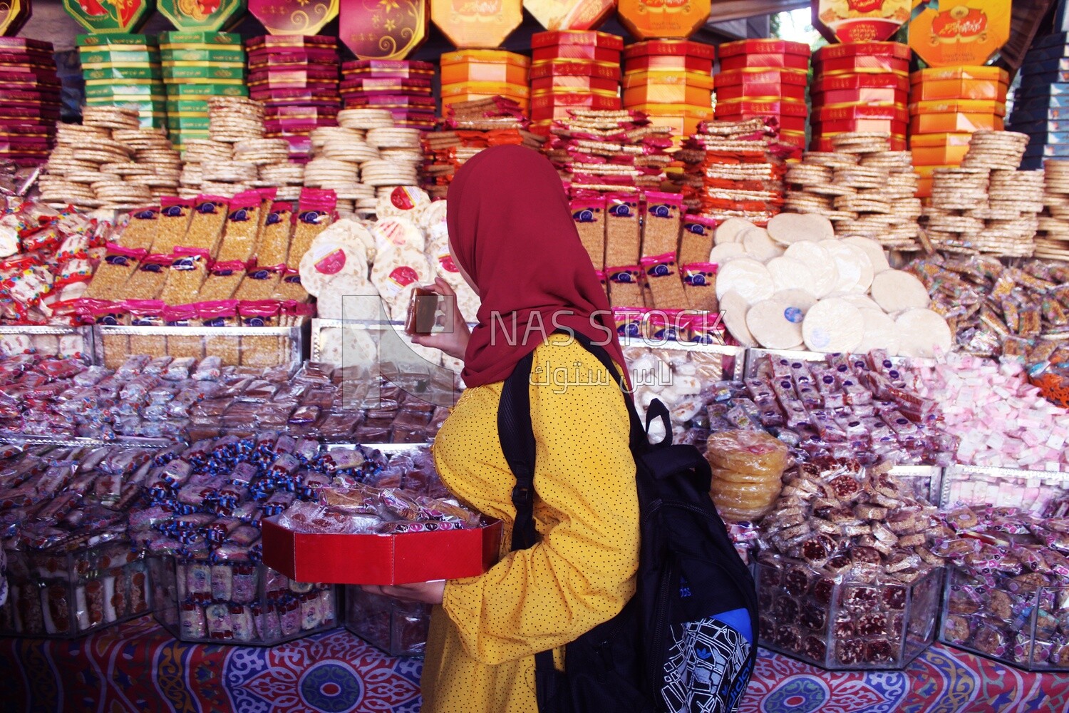 Woman puts the candies of the prophet Muhammad&#39;s birth on the box