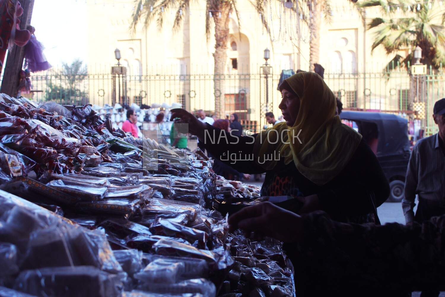 Woman puts the candies of the prophet Muhammad&#39;s birth on the box