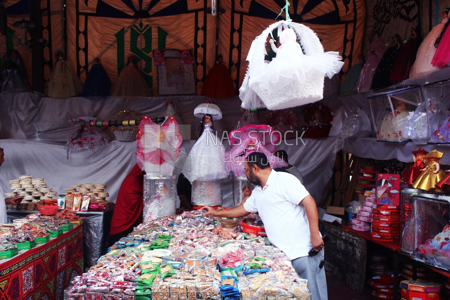 Man puts the candies of the prophet Muhammad&#39;s birth on the box