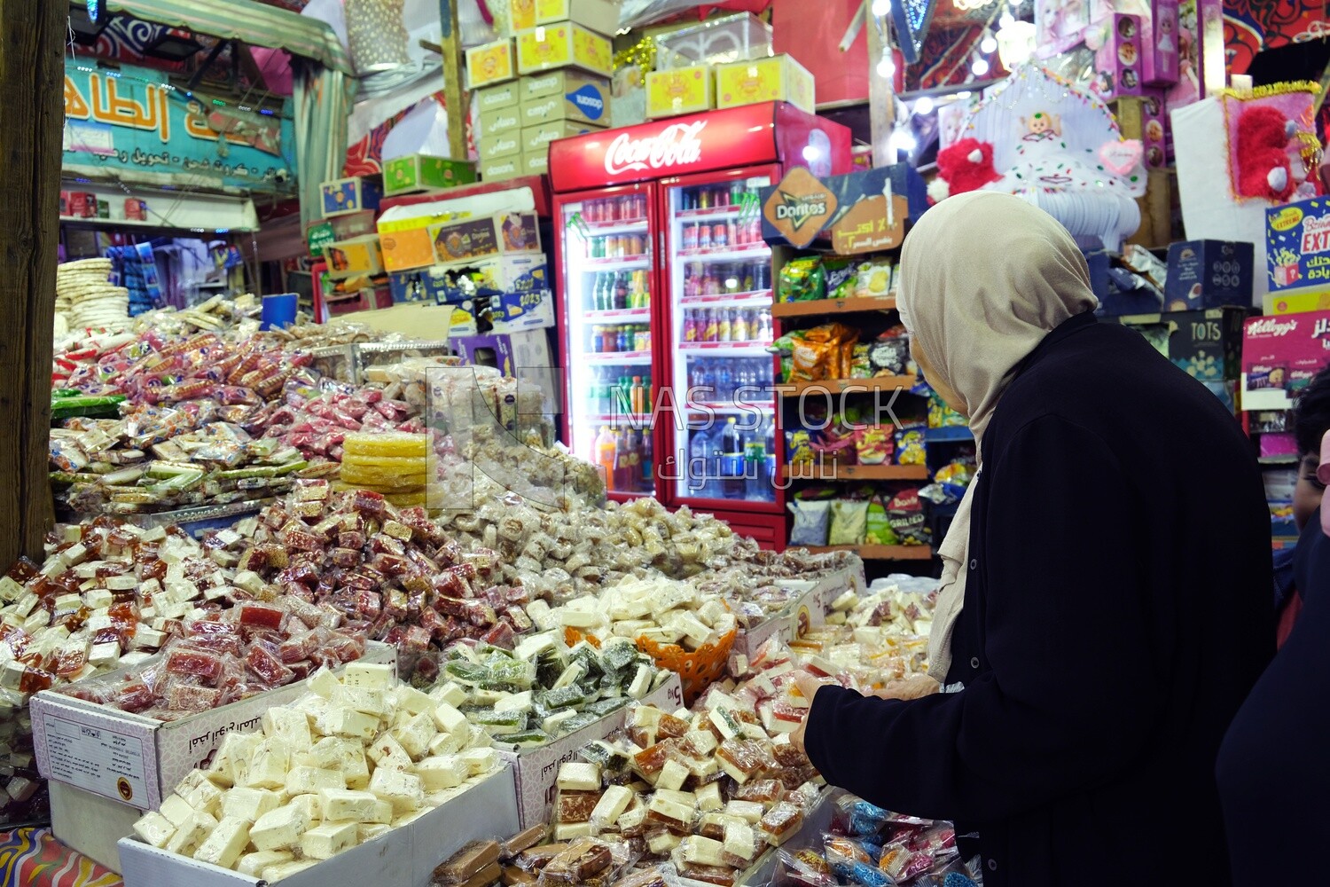 Woman puts the candies of the prophet Muhammad&#39;s birth on the box
