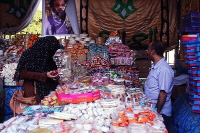 Woman puts the candies of the prophet Muhammad&#39;s birth on the box