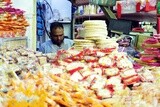 Man standing selling the candies of the prophet Muhammad&#39;s birth in the street