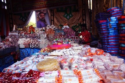 Man standing selling the candies of the prophet Muhammad&#39;s birth in the street