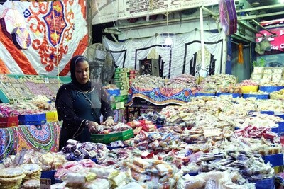 Woman puts the candies of the prophet Muhammad&#39;s birth on the box