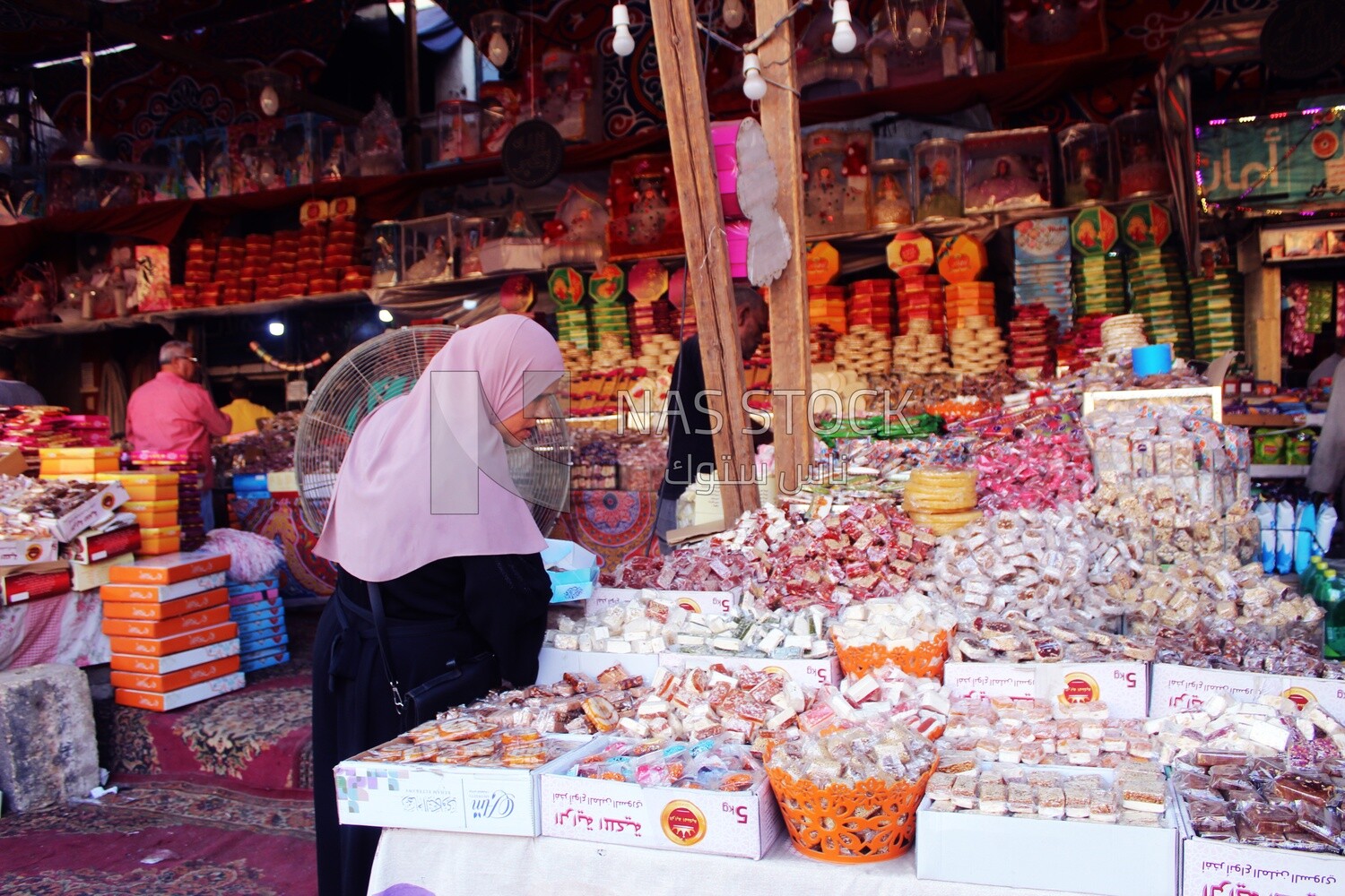 Woman puts the candies of the prophet Muhammad&#39;s birth on the box
