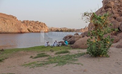 Group of Nubian men sitting on the bank of the Nile River