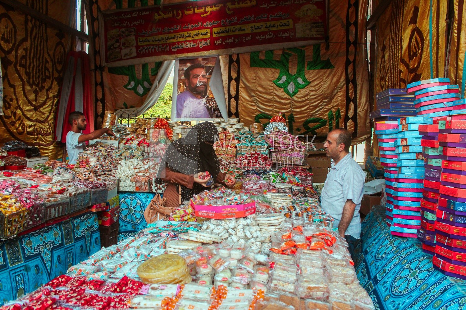Woman puts the candies of the prophet Muhammad&#39;s birth on the box