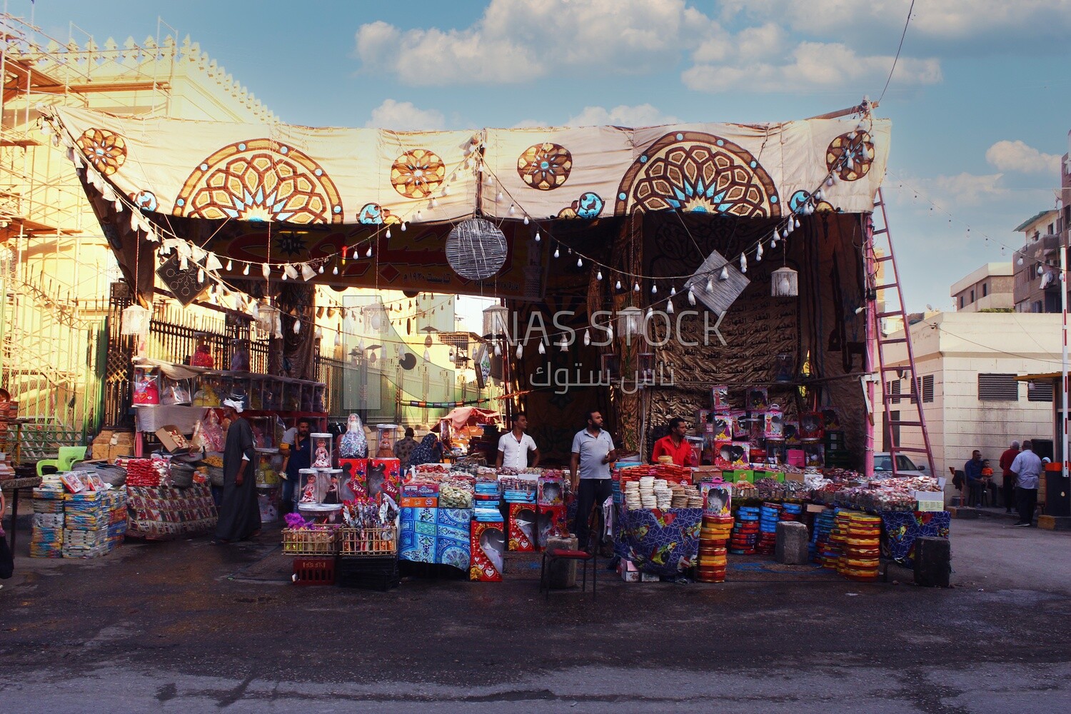 Men standing selling the candies of the prophet Muhammad&#39;s birth in the street