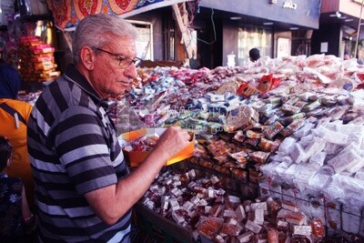 Man puts the candies of the prophet Muhammad&#39;s birth on the box