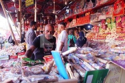 Man puts the candies of the prophet Muhammad&#39;s birth on the box