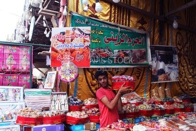 Man standing selling the candies of the prophet Muhammad&#39;s birth in the street