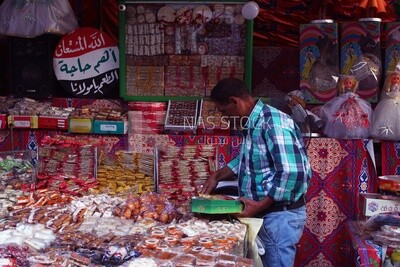 Man puts the candies of the prophet Muhammad&#39;s birth on the box