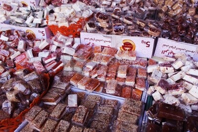 View of Collection of Arabian Sweet Candies with Nuts, Peanuts, Hazelnuts, and Pistachios in the Street, Egyptian Desserts of Prophet Muhammad&#39;s Birth Celebration