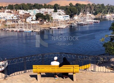 Man and his wife sit in Ferial Garden overlooking the Nile River in Aswan, Egypt