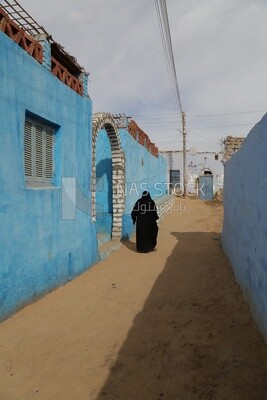 Old woman walking down the street, Egypt
