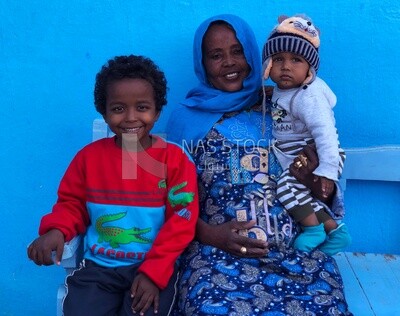 Nubian mother sitting with her two children ,Aswan, Egypt