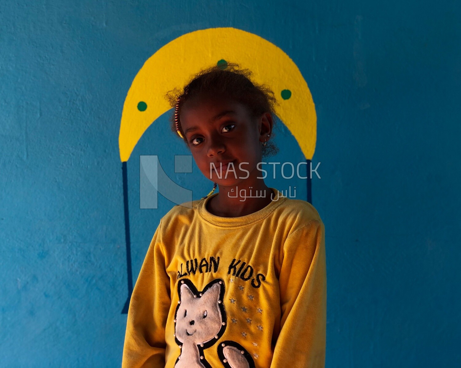 Beautiful girl stands in the window of the house, Egypt