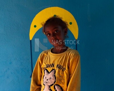 Beautiful girl stands in the window of the house, Egypt