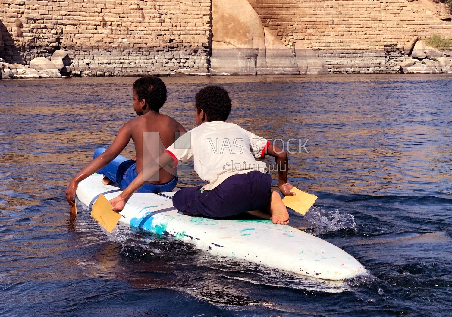 Two children riding a boat, Aswan, Egypt