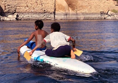 Two children riding a boat, Aswan, Egypt
