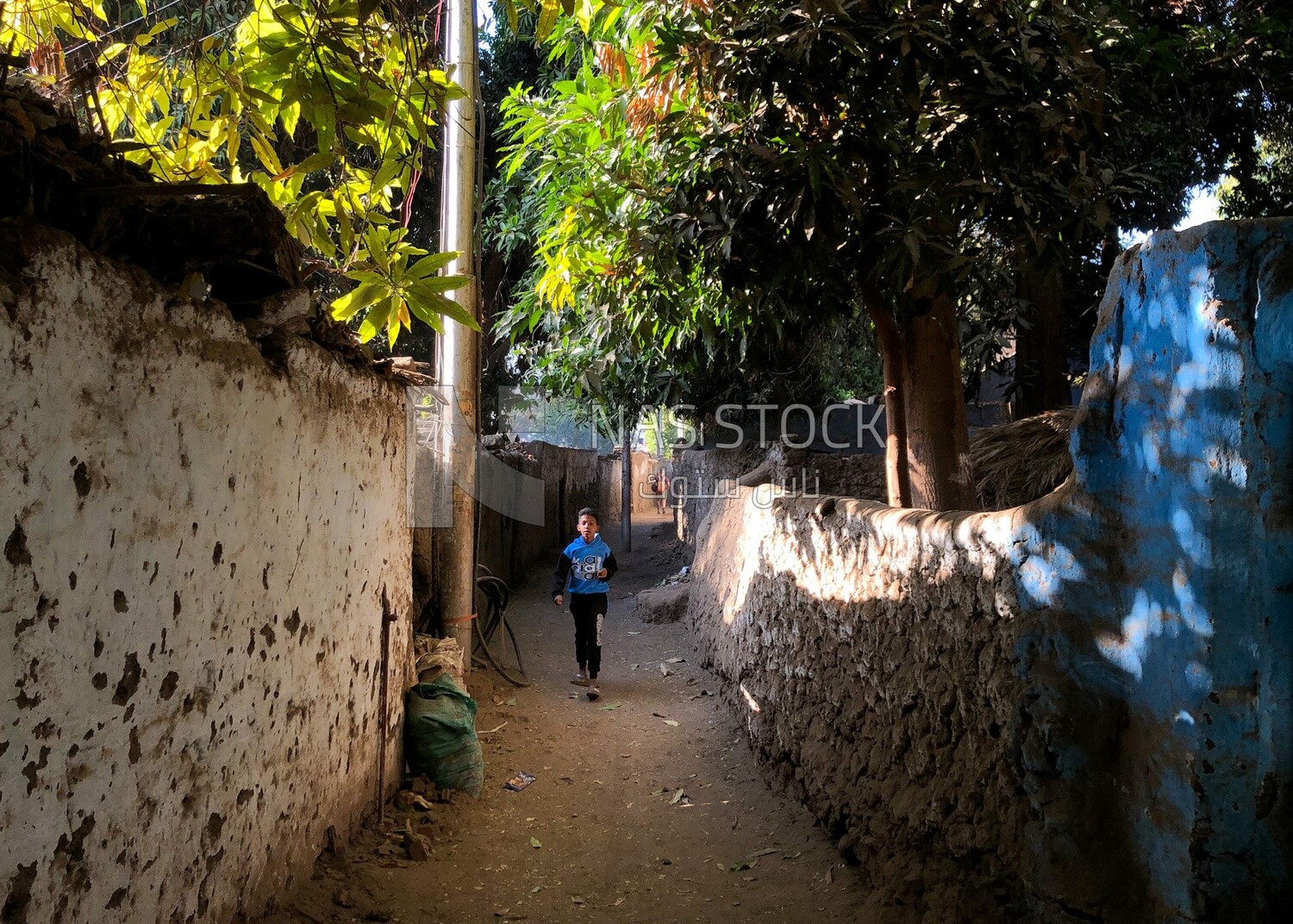 Child walking in the street, Aswan City, Egypt