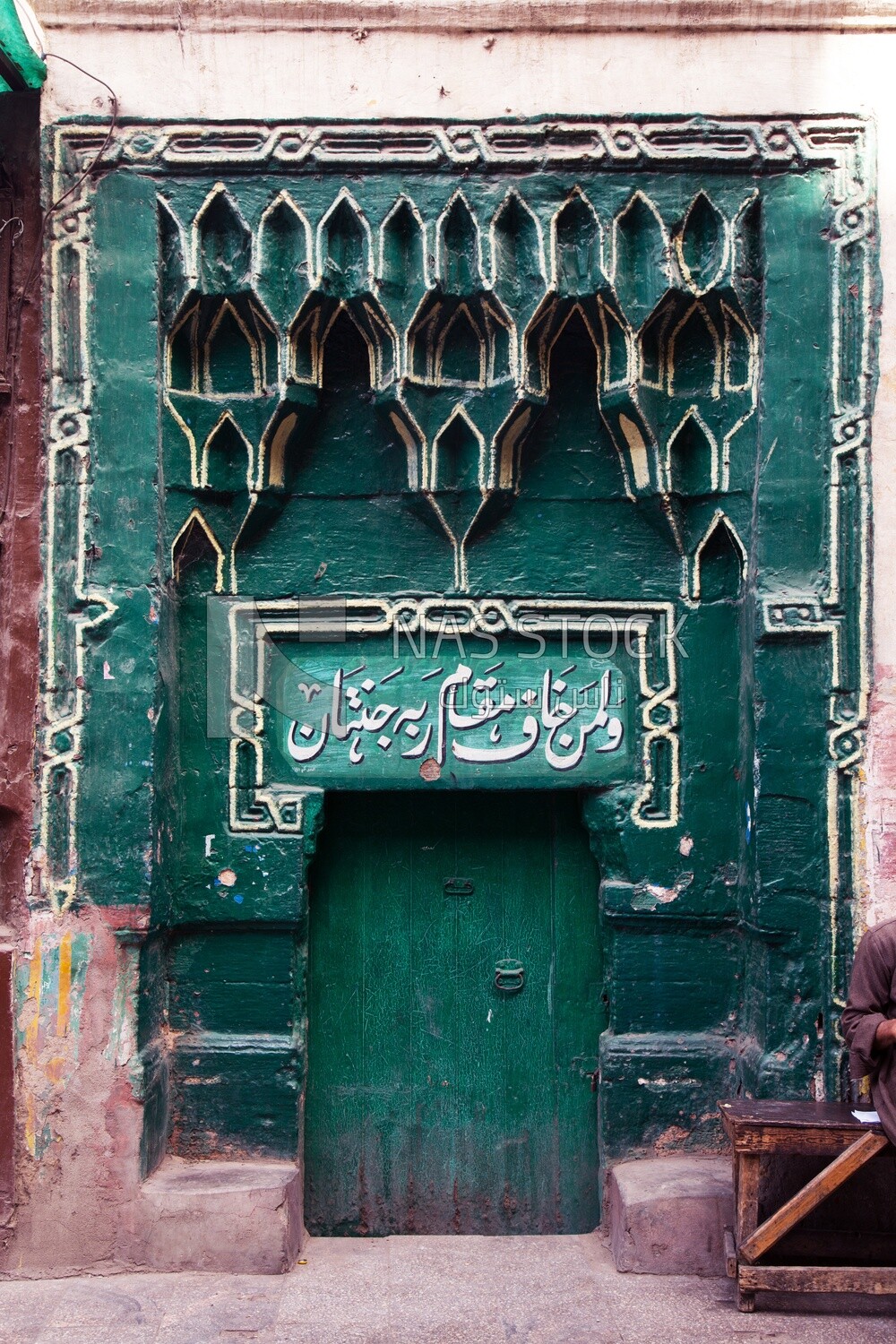 Old wooden entrance with a Quranic verse written on it, an Islamic door in Islamic Cairo, Egypt