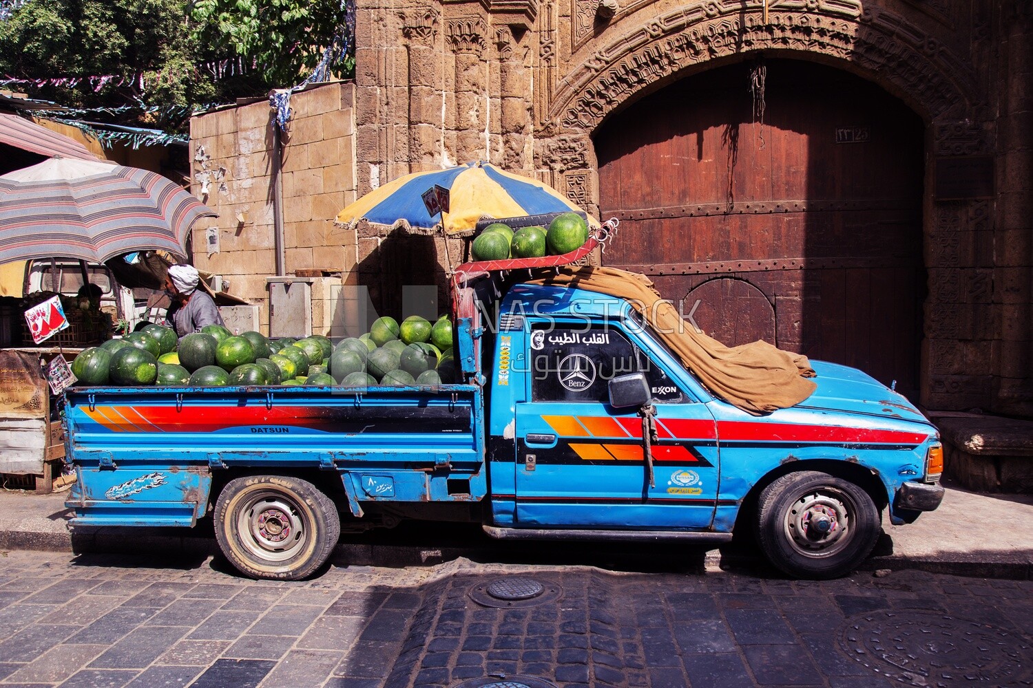 Blue truck loaded with watermelons