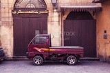 Suzuki pickup truck parked in front of one of the closed shops on Al Moez Street in Cairo