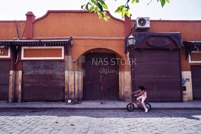 Girl rides a bicycle on Al-Moez Street in Cairo, Egypt.