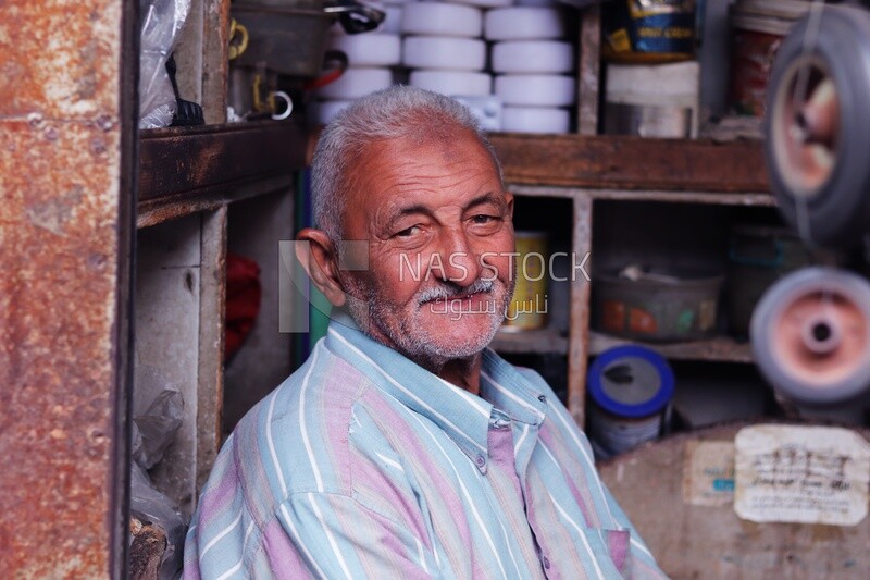 Man sitting in front of a shop