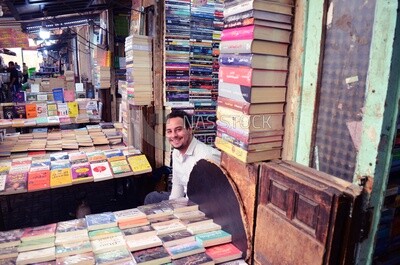 Seller sits in a bookstore in the Sur Al-Azbakeya area in Ataba,Egypt