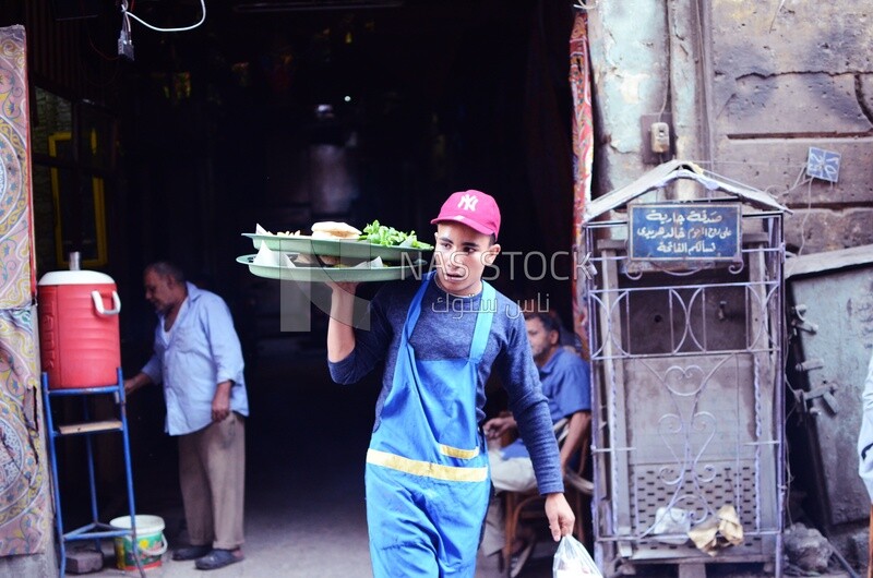 Young man carries food from the popular restaurant, Egypt