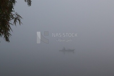 Man on a boat in the middle of the sea during the foggy weather, foggy weather