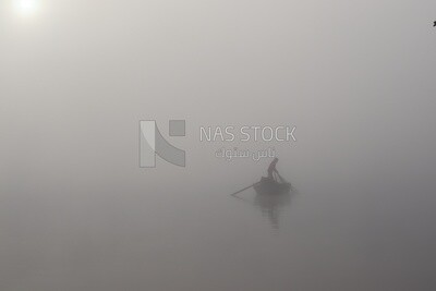 Man on a boat fishing in the middle of the sea during foggy weather, foggy weather