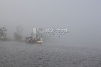 People waiting for the ferry boat on a foggy day, Sea transportation