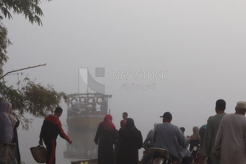 People waiting for the ferry boat on a foggy day, Sea transportation