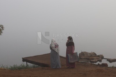People waiting for the ferry boat on a foggy day, Sea transportation