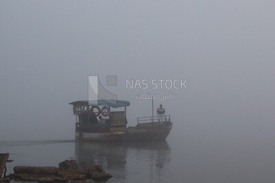 Man on a boat in the middle of the sea during the foggy weather, foggy weather