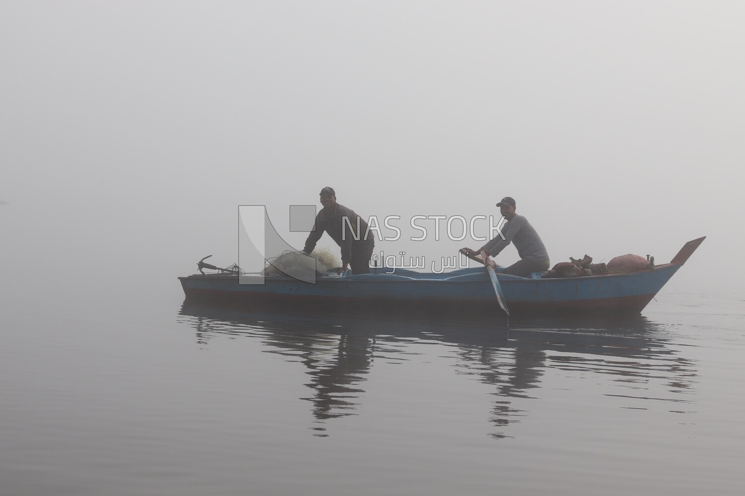 Two men on a boat fishing in the middle of the sea during foggy weather, foggy weather