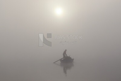 Man on a boat fishing in the middle of the sea during foggy weather, foggy weather