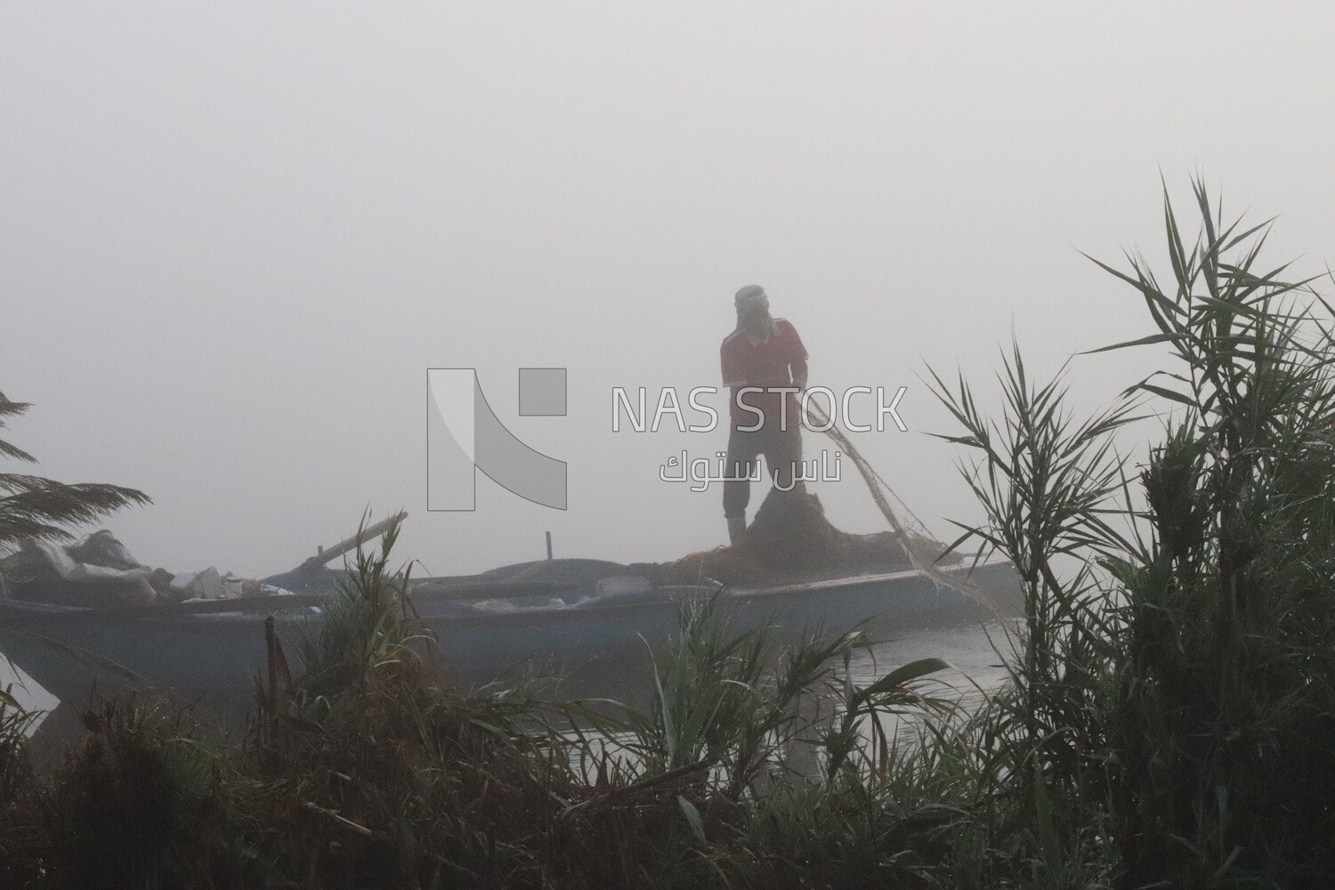 Man on a boat fishing in the middle of the sea during foggy weather, foggy weather