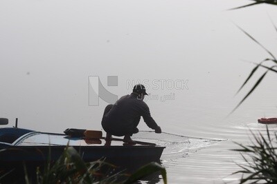 Man on a boat fishing in the middle of the sea during foggy weather, foggy weather
