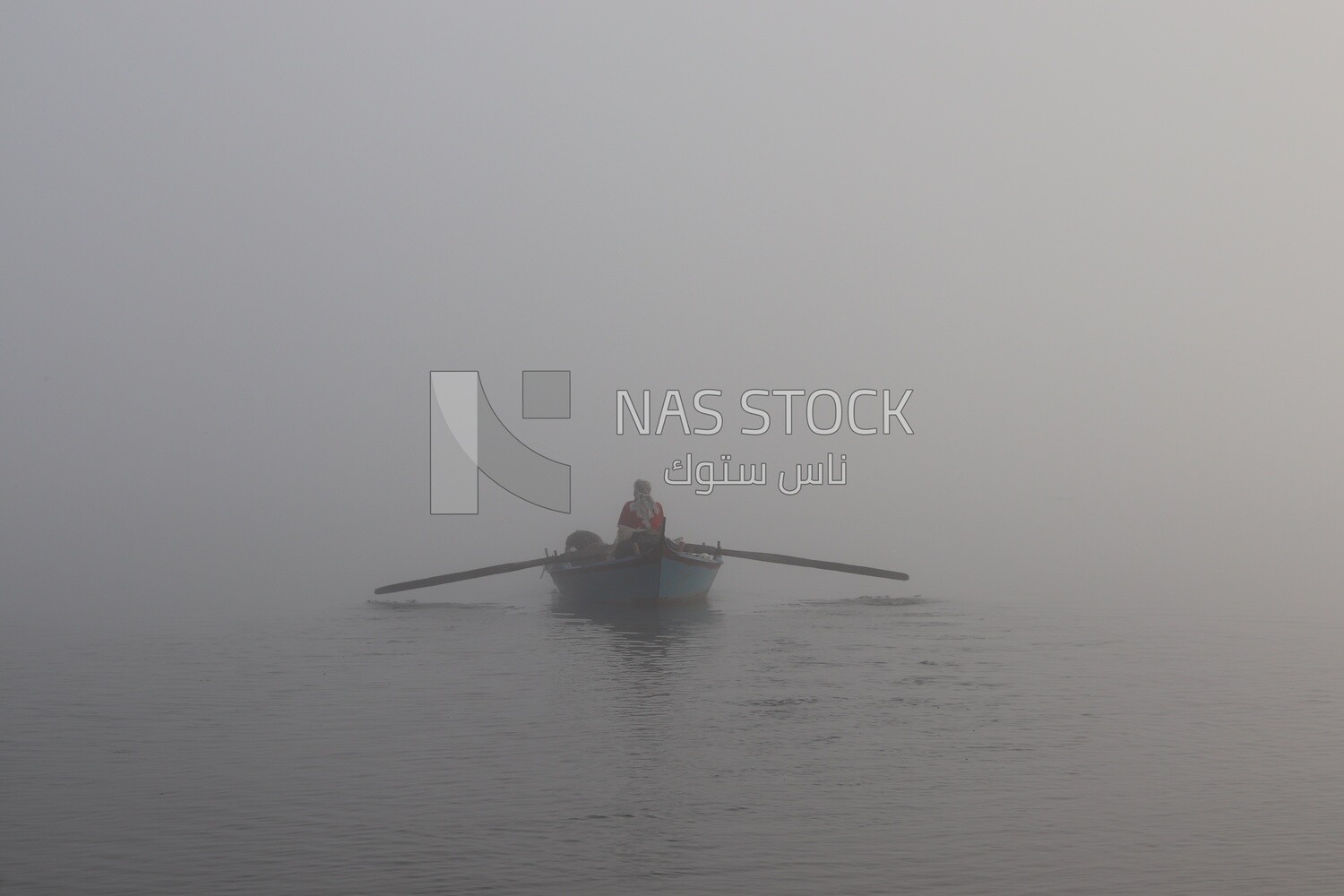 Man on a boat fishing in the middle of the sea during foggy weather, foggy weather