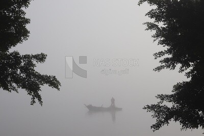 Man on a boat fishing in the middle of the sea during foggy weather, foggy weather
