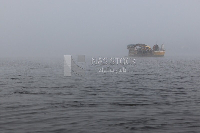 People on the ferry boat on a foggy day, Sea transportation