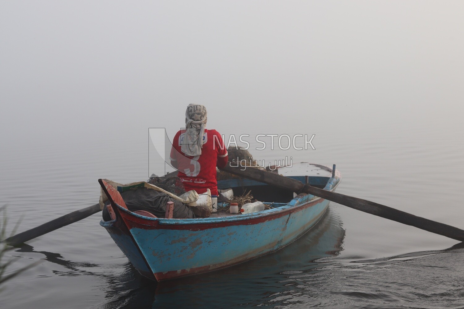 Man on a boat fishing in the middle of the sea during foggy weather, foggy weather
