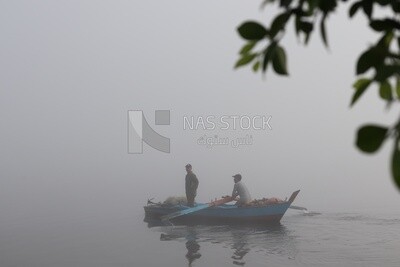 Two men on a boat fishing in the middle of the sea during foggy weather, foggy weather