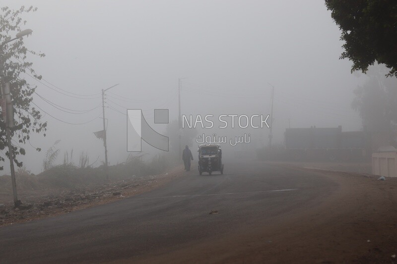 Tuk tuk on the road during foggy weather