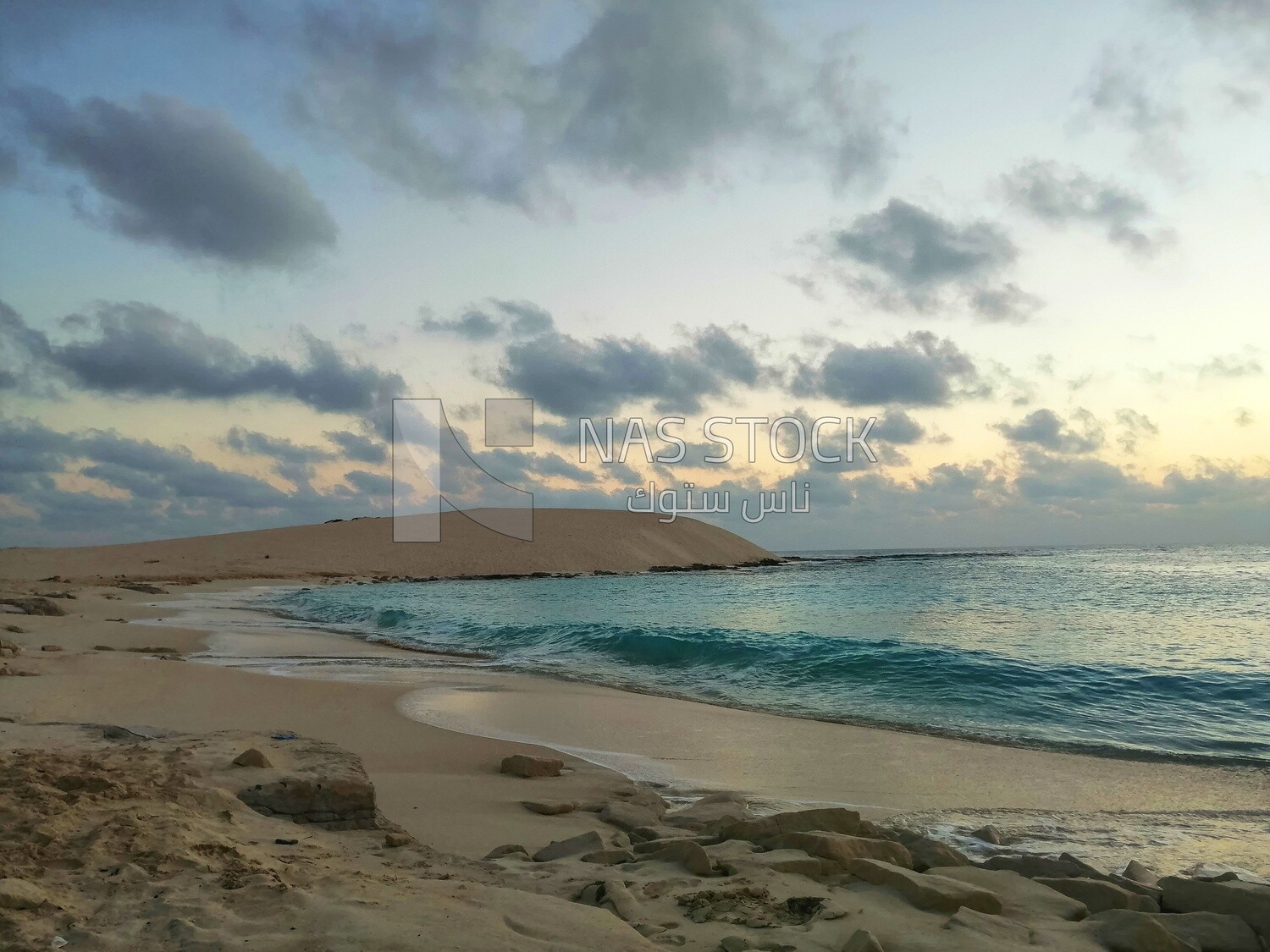 View of the white sand dunes and blue water in Marsa Matruh 