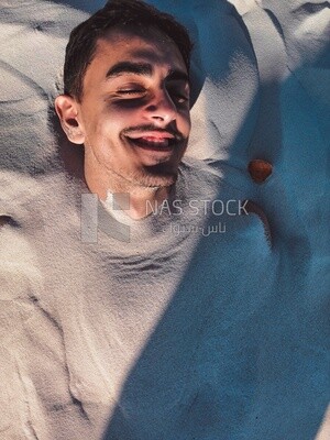 Man buried in the sand at the beach